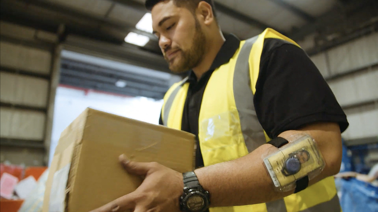 Man carrying package in factory