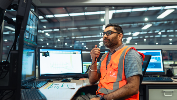 Worker in front of a set of monitors
